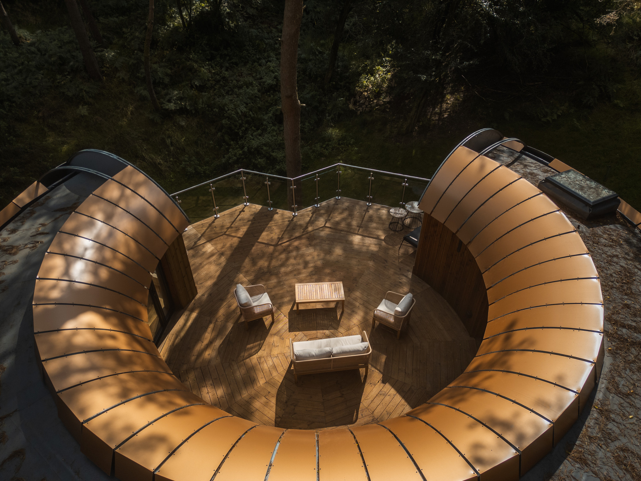 Liberty Treehouse TreeDwellers Aerial shot of 2 bedroom Liberty treehouse at TreeDwellers, Cornbury. Taken from above, this photo shows Liberty's vast balcony and incredible shape.